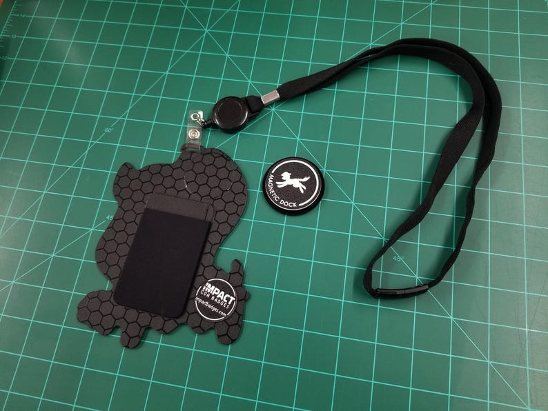 Back view of the badge. Orders include lanyard, badge reel, card holder, magnetic dock, and NFC chip for sharing links.