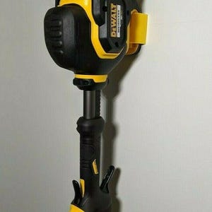 May include: A black and yellow DeWalt cordless string trimmer. The trimmer has a black handle and a yellow and black head. The DeWalt logo is visible on the side of the head. The trimmer is designed for lawn care.