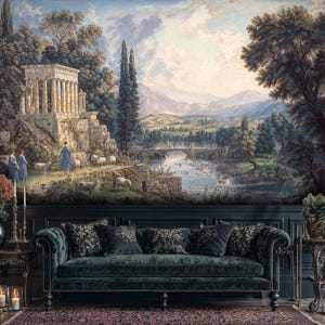 May include: A detailed mural depicting a classical landscape with a temple, figures, and sheep near a river and bridge. The mural is above a dark green velvet sofa with decorative pillows. The scene evokes a sense of history and tranquility.