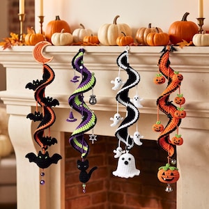 May include: Four hanging crochet spiral decorations featuring Halloween themes. One has black bats and a crescent moon, one has purple and green stripes with witch hats, one has white ghosts, and one has orange pumpkins with a large jack-o'-lantern.