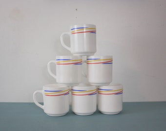 vintage set of six milk glass mugs with primary color design by Arcopal France
