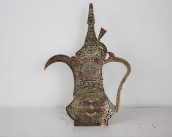 beautiful vintage brass 100 year desk top calendar in the shape of a coffee pot or tea pot. wheel turns for date 1992 to 2091