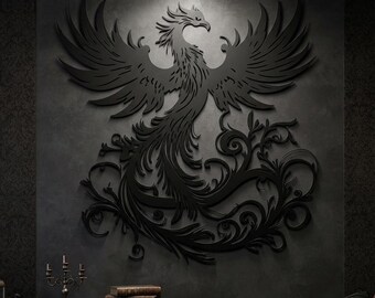May include: A large, matte black wall art piece featuring a detailed, laser-cut silhouette of a phoenix with expansive, feathered wings and an intricate, swirling tail design. The mythical bird is centered, displaying sharp, defined edges.