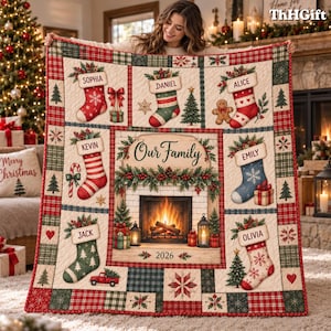 May include: A quilted throw blanket featuring a central fireplace illustration with the text Our Family and 2026. The design includes six personalized stockings labeled Sophia, Daniel, Alice, Kevin, Emily, Jack, and Olivia, surrounded by plaid borders.