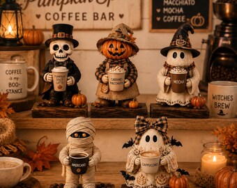 May include: Five decorative Halloween figurines standing on wooden bases, each holding a coffee cup labeled Pumpkin Spice Latte, Caramel Macchiato, Mocha, Americano, or Cappuccino. The figures include a skeleton, a pumpkin, a ghost, a mummy, and a ghost with a bow.