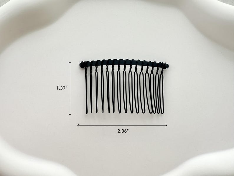 May include: Black plastic hair comb with 14 teeth. The comb is 2.36 inches wide and 1.37 inches tall.