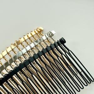 May include: A set of three hair combs with a twisted wire design. The combs are gold, silver, and black.