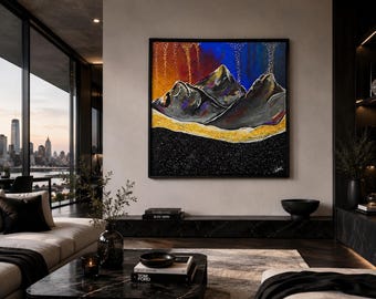 May include: A square framed painting featuring dark grey mountain peaks against a vibrant background of orange and blue. A thick, textured gold glitter band runs horizontally across the base of the mountains, set against a black starry sky.