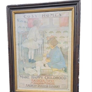 May include: Framed vintage advertisement for American Radiator Company. The artwork depicts two children in a cozy home setting. The text reads "COSY HOMES" and "MAKE HAPPY CHILDHOOD". The frame is dark brown with a gold inner border.