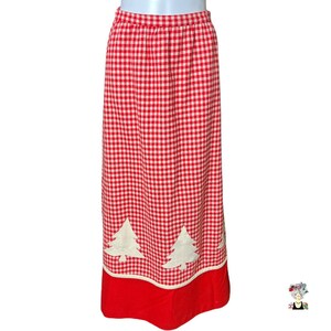 May include: A red and white gingham skirt with a red bottom hem and white embroidered Christmas trees.