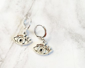 Evil Eye Huggie Earrings. Silver Evil Eye Studs. Silver Dangling Earrings. Evil Eye Jewelry. Evil Eye Earrings. Silver Huggie Earrings.