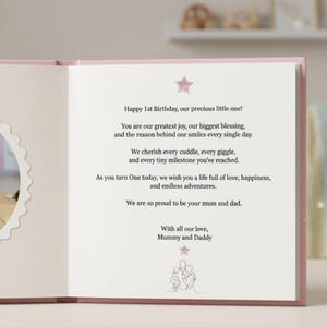 May include: An open book with a pink star at the top and bottom. The text reads: Happy 1st Birthday, our precious little one! You are our greatest joy, our biggest blessing, and the reason behind our smiles every single day. We cherish every cuddle, every giggle, and every tiny milestone you've reached. As you turn One today, we wish you a life full of love, happiness, and endless adventures. We are so proud to be your mum and dad. With all our love, Mummy and Daddy.