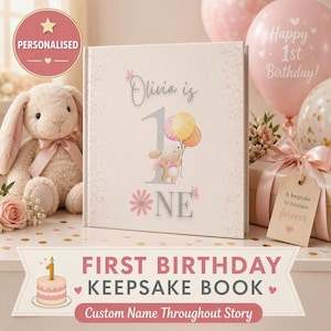May include: A square hardcover keepsake book with a cream cover featuring the text Olivia is 1, a cartoon bunny holding balloons, and a pink flower. The book is displayed alongside a plush bunny, pink balloons, and a gift box with a tag.