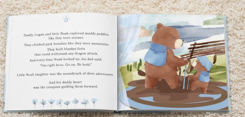 Puede incluir: Un libro infantil abierto con una ilustraci&oacute;n en acuarela de un oso pardo grande y un oso pardo peque&ntilde;o con mochilas azules en un charco de barro. La p&aacute;gina izquierda contiene el texto negro: Daddy Logan and little Noah explored muddy puddles like they were oceans. They climbed park benches like they were mountains. They built blanket forts that could withstand any dragon attack. And every time Noah looked up, his dad said: I'm right here. Go on. Be bold. Little Noah laughter was the soundtrack of their adventures. And his daddy heart was the compass guiding them forward.