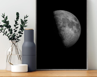 May include: A black and white photograph of a crescent moon against a dark background. The moon is in the upper right corner of the image.