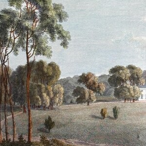 May include: An antique landscape print depicts a serene countryside scene. Tall trees with green foliage frame a grassy field dotted with smaller trees. A white building is visible in the distance, under a pale blue sky.