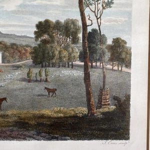May include: A detailed, vintage landscape print featuring a pastoral scene with trees, horses, and a flock of sheep. The artwork is rendered in a detailed, engraved style with a muted color palette of greens, browns, and blues. The print is signed.