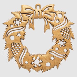 May include: Wooden Christmas wreath with a bow at the top. The wreath is carved with pinecones, stars, and snowflakes. The wreath is made of light-colored wood and has a natural finish.