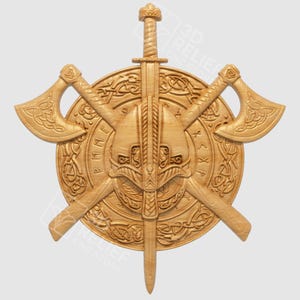 May include: A wooden relief carving of a Viking shield with a sword, two axes, and a helmet. The shield is round with runic inscriptions and Celtic knotwork. The axes and sword are crossed behind the helmet.