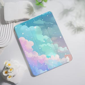 May include: A rectangular tablet case featuring a printed design of a night sky filled with fluffy clouds in shades of pastel pink, blue, and purple, accented with small white stars scattered across the surface in a repeating pattern.