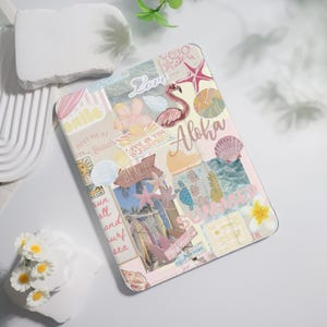 May include: A pastel-colored tablet case with a collage design featuring beach-themed elements. The design includes a flamingo, starfish, seashells, and the word "Aloha." Other text includes "Beach," "Smile," and "Summer."