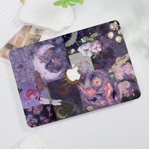 May include: A decorative laptop cover featuring a collage of celestial and floral imagery. The design includes a crescent moon, stars, koi fish, and various flowers in shades of purple, pink, and white. The Apple logo is visible.