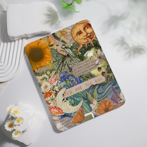May include: A decorative rectangular item with a collage design featuring a sunflower, butterfly, moon, and sun. The text "YOU ARE THE SUN" is visible. The item has a vintage, botanical theme with a variety of flowers and other natural elements.