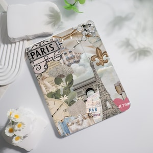 May include: A collage-style design featuring the Eiffel Tower, the Arc de Triomphe, and other Parisian landmarks. The design also includes floral elements, a clock, and the word "PARIS" in a decorative font.