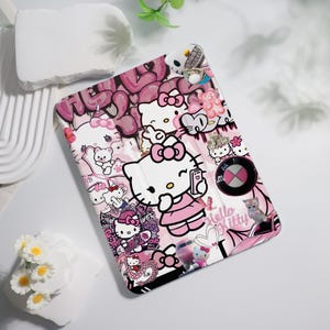 May include: Pink and white tablet case featuring Hello Kitty and other cartoon characters. The case has a collage design with graffiti-style lettering and various images, including a BMW logo and a small cat.