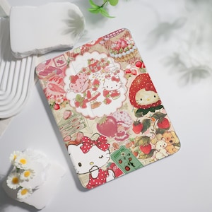 May include: A rectangular tablet case featuring a collage of Hello Kitty and Strawberry Shortcake characters, red strawberries, and green leaves. The design includes a white scalloped frame, a green ticket labeled ADMIT ONE, and red polka dots.