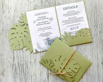 May include: A green wedding invitation with a cut-out tropical leaf design. The invitation is for Kimberly Marie Uftring and Christopher William Shingler. The wedding will be held on Saturday, 25th August 2012 at 3 o'clock in the afternoon at The Ivy Country Club, 3900 Serra Buena Boulevard, San Francisco, CA.