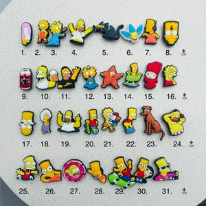 May include: A set of 31 colourful cartoon character charms featuring the Simpsons characters. The charms are made of rubber and are designed to be used as shoe charms.