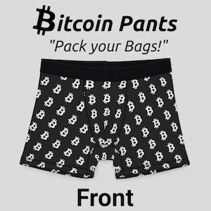 May include: Black boxer shorts with a white Bitcoin symbol pattern. The text "Pack your Bags!" and "Bitcoin Pants" are printed on the image.