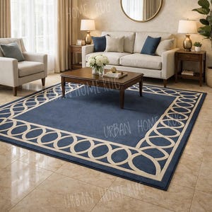 May include: A navy blue rug with a cream geometric border in a living room. The rug is under a dark brown coffee table and a cream sofa with blue cushions. The room has beige walls and a large window with curtains. The rug measures approximately 240 x 300 cm.
