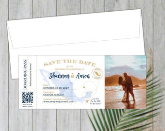 May include: A Save the Date card designed as a boarding pass with a blue map of Mexico, gold text, a QR code, and a photograph of a couple on a beach at sunset. The text includes the names Shannon and Aaron, the date October 16-18, 2027, and Cancun.