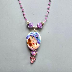 Lampwork woman with purple hat necklace