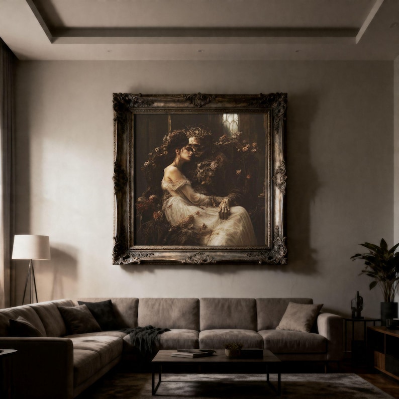 May include: A large, ornate, dark-toned rectangular frame containing a painting of a figure in a flowing white gown seated beside a skeletal figure adorned with a crown, set against a dark, moody background with floral elements and soft lighting.