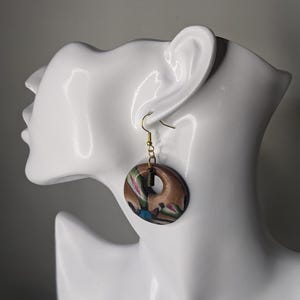 Multicolored creoles on brown gradient, handmade.