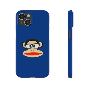May include: A blue phone case featuring a cartoon monkey face with glasses and a red mouth. The case is shown from the front and side, highlighting its design and form. The monkey face is a recognizable graphic.