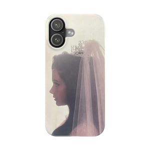 May include: A phone case with a portrait of a woman in profile, wearing a crown and veil. The image has a soft, romantic feel with a vintage style. The case is white with a clear border.