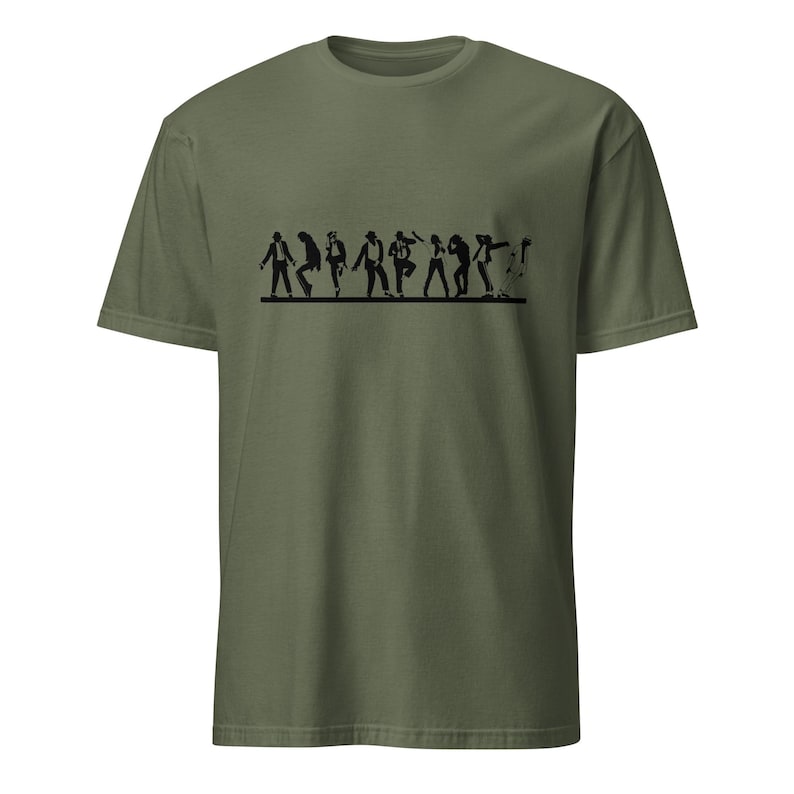 May include: Olive green t-shirt featuring a black graphic of stylized figures in various dance poses. The figures are arranged in a horizontal line across the chest of the shirt. The t-shirt has short sleeves and a crew neck.