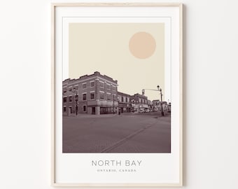 May include: A sepia-toned photograph of a street scene in North Bay, Ontario, Canada. The image features a row of brick buildings with a large, pale yellow circle in the sky.