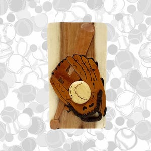 May include: A wooden baseball themed puzzle box with a baseball glove, bat, and ball. The box is made of light brown wood and has a natural wood grain.
