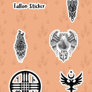 May include: A collection of tattoo stickers with various black and white designs. The stickers include a wolf, an eagle, and other tribal-inspired symbols. The words "Tattoo Sticker" are printed at the top.