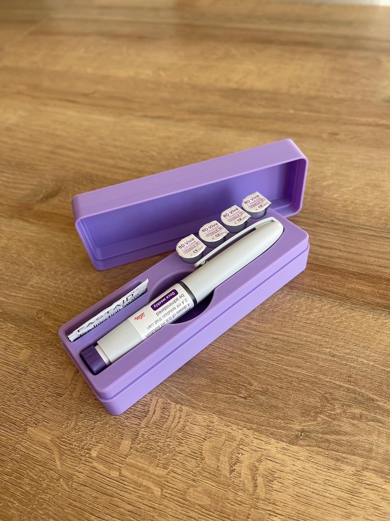 May include: A purple case with a white pen-like object inside. The case also contains four small round containers with labels that say "RD Viva" and "Single Use".