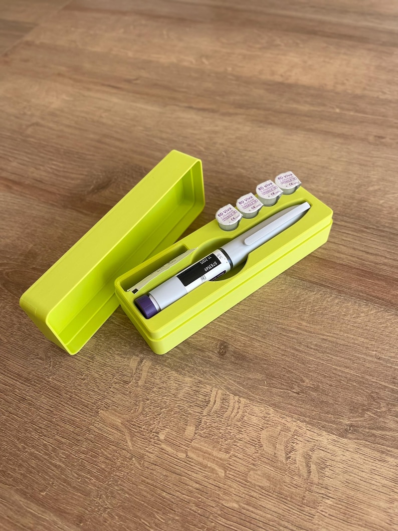 May include: A lime green plastic case with a lid, containing a pen-like medical device and five small white vials with purple labels. The vials have the text "BD Viva 32G 8mm" printed on them.