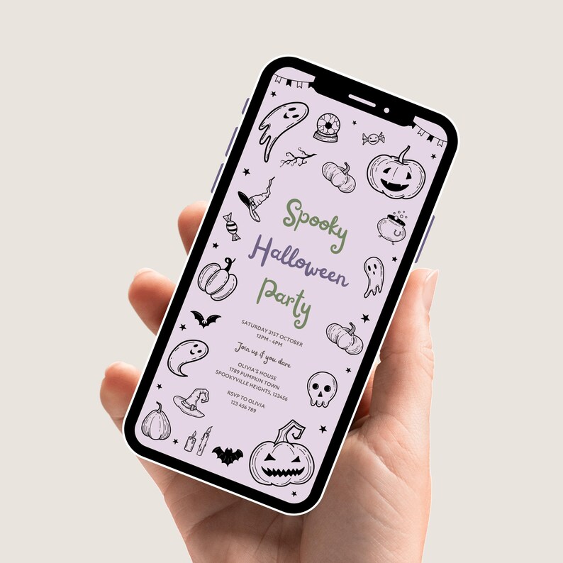 A hand holding a phone displaying the Kids Halloween Party invitation, showcasing it in real-life context.