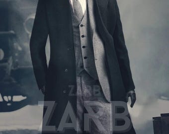 May include: A man wearing a black overcoat, a grey waistcoat, and a grey patterned suit. He is also wearing a grey newsboy cap and black gloves. The text "ZARB TAILOR MADE" is visible on the image.