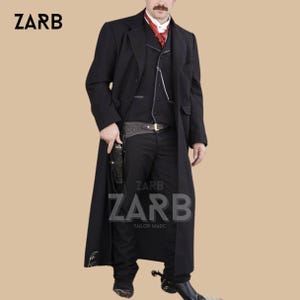 May include: A black, long coat with a matching vest and pants. The outfit includes a red ascot and a gun holster. The brand name "ZARB" is visible in the image. The coat is a classic western style.