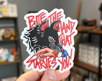 Pegatina «Muerde la mano que te mata de hambre»